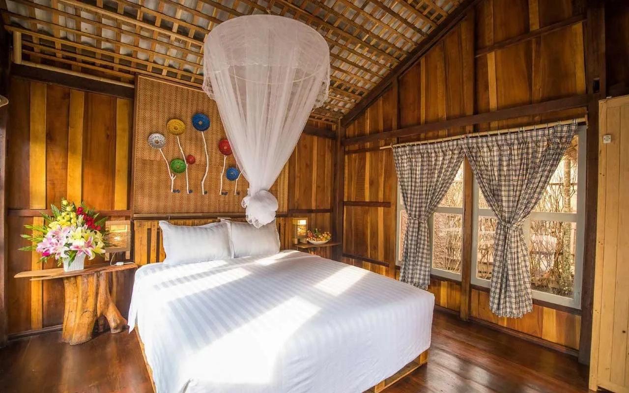 A wooden room with traditional design offering warmth and tranquility at Mekong Rustic.