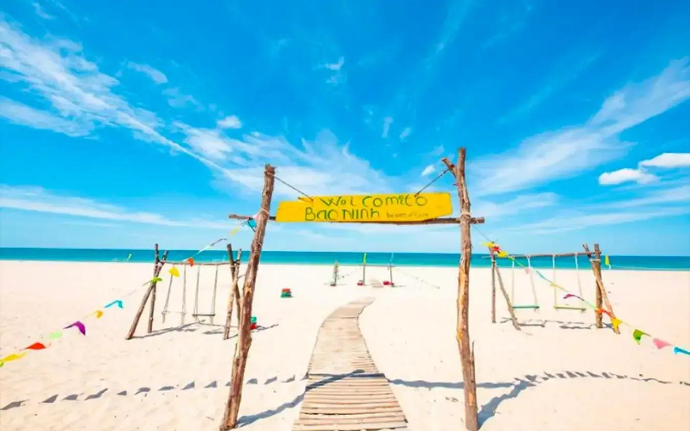 Bảo Ninh Beach with clear blue skies and fine sand.