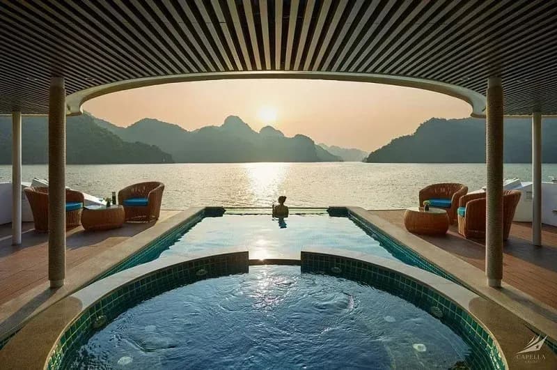 Enjoy a tranquil moment at Capella's pool amidst enchanting sunset scenery.