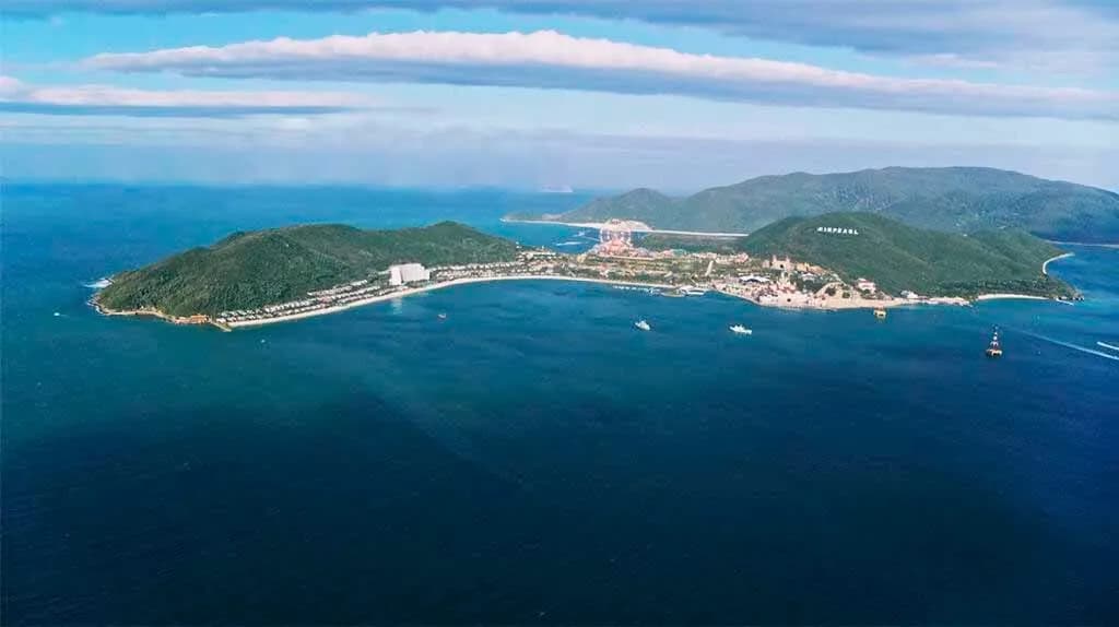 View of Hon Tre Island surrounded by blue sea and luxury resorts.