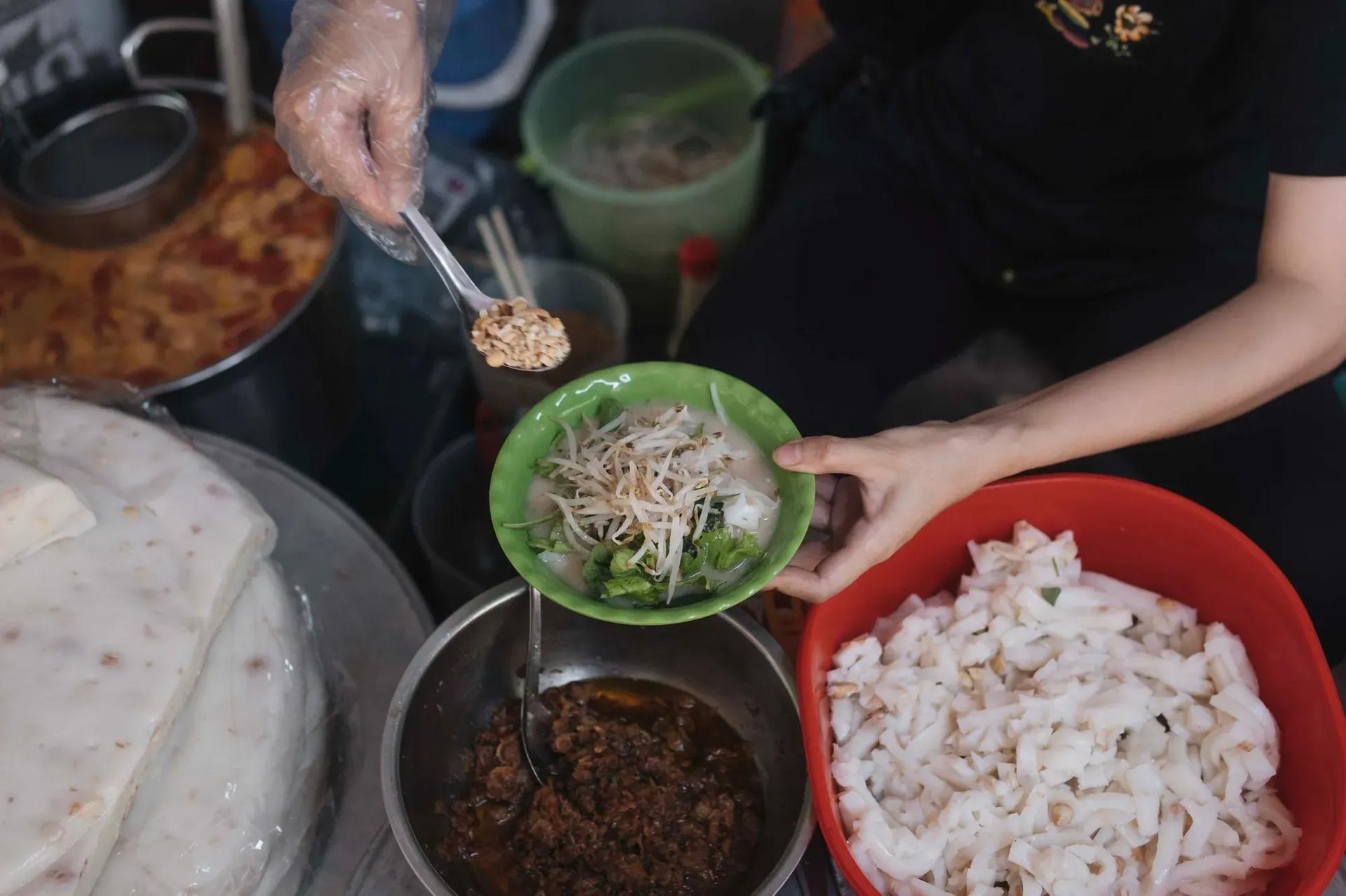 Complete banh duc rieu cua bowl with peanuts and vegetables