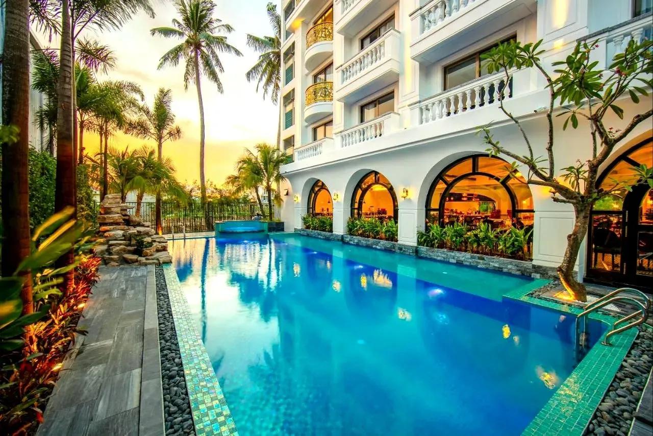Outdoor pool of Grand Sunrise Palace Hoi An, shining under the sunset glow.