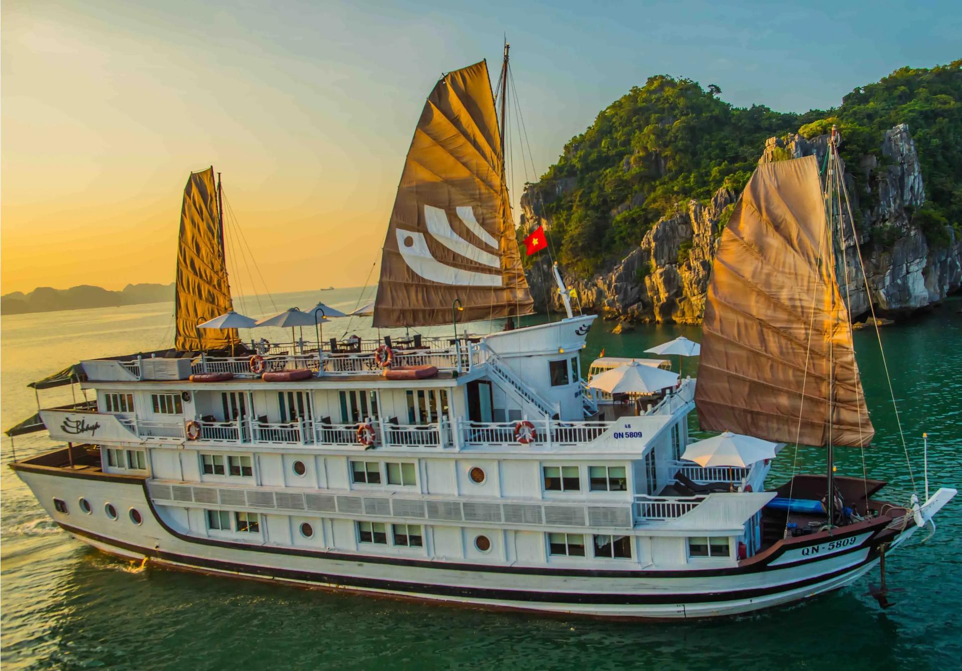 Bhaya Cruise glowing under the sunset in Ha Long Bay.