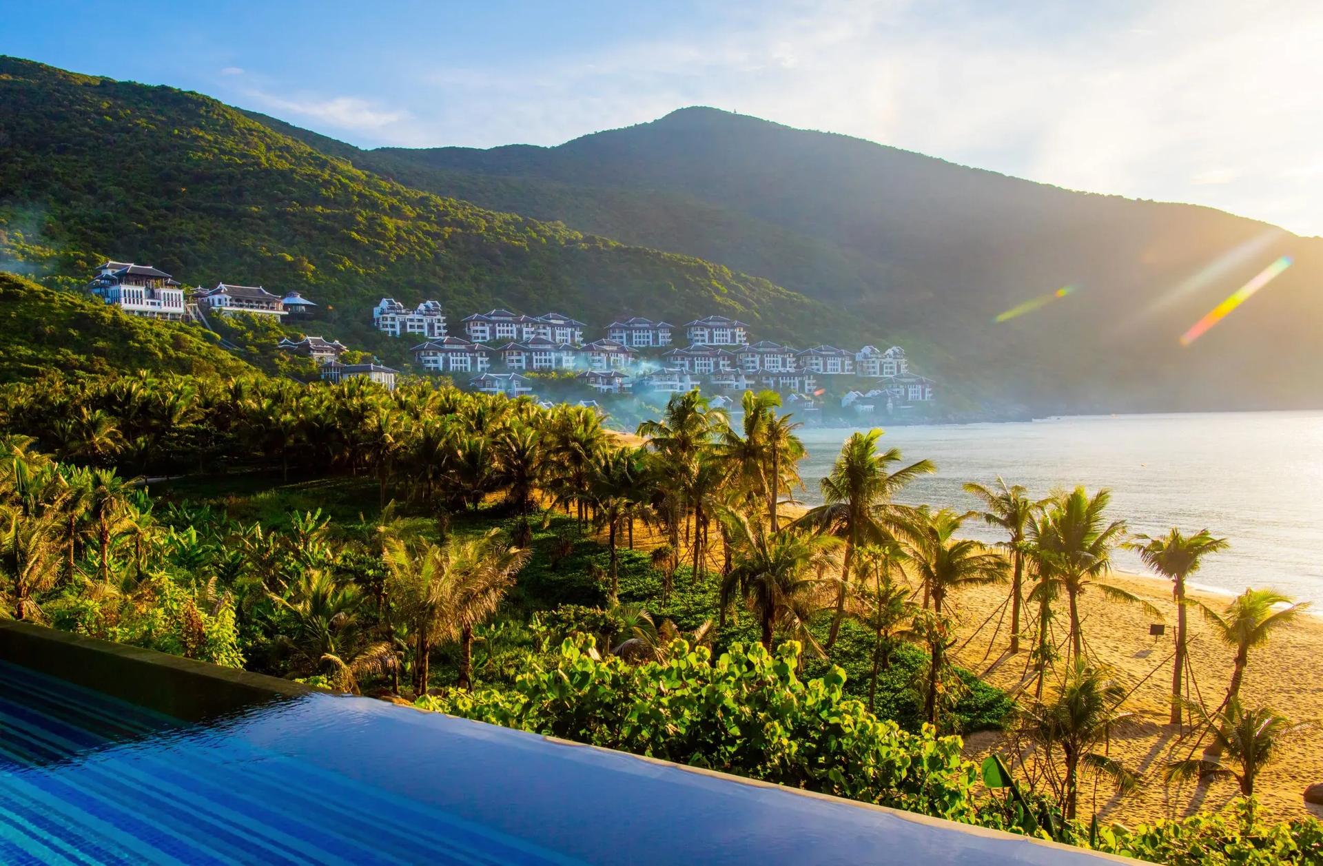 Pristine beauty of Son Tra Peninsula with lush green coastlines and white sand.