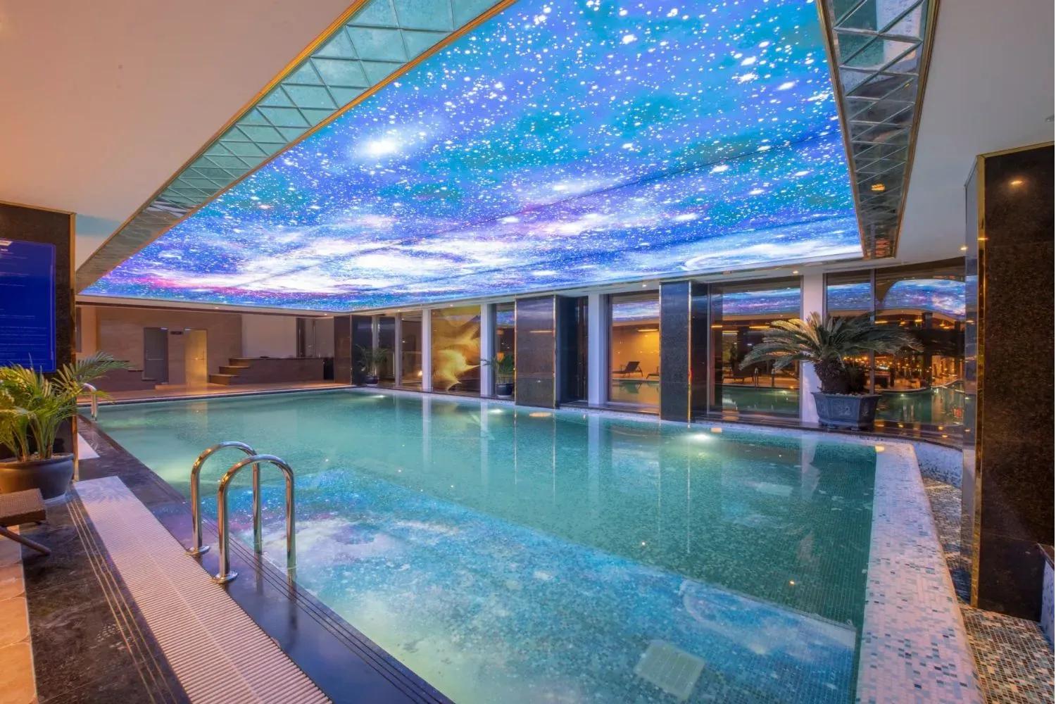 Indoor pool with starry ceiling at Wyndham Garden Hanoi.