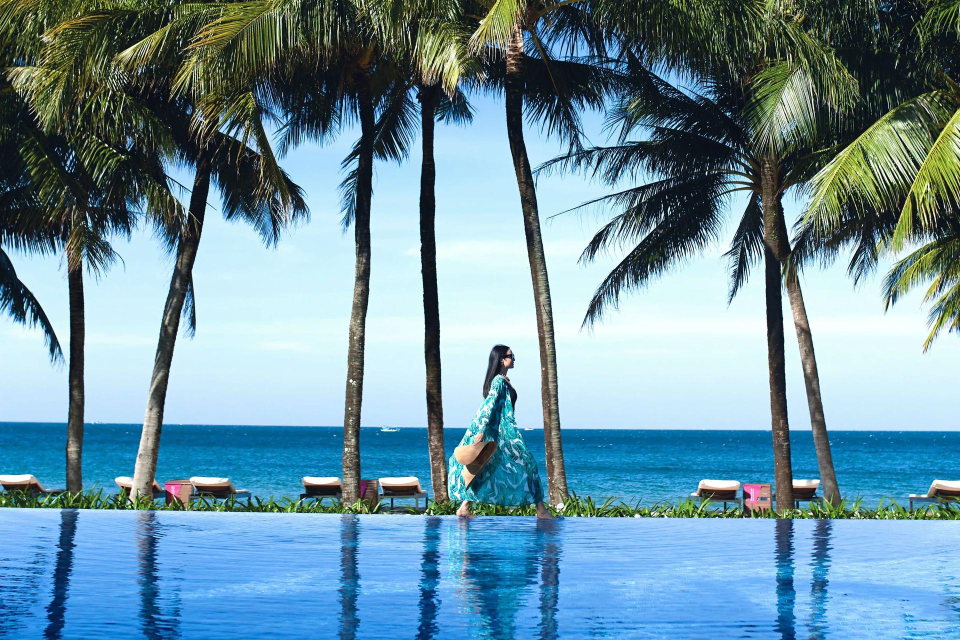 Visitor strolling by the blue sea at Salinda Resort
