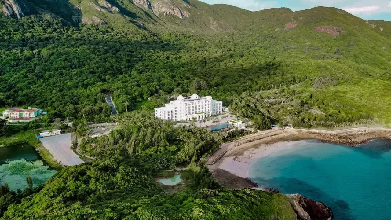 Aerial view of Orson Hotel & Resort Côn Đảo nestled in lush greenery and private beach.
