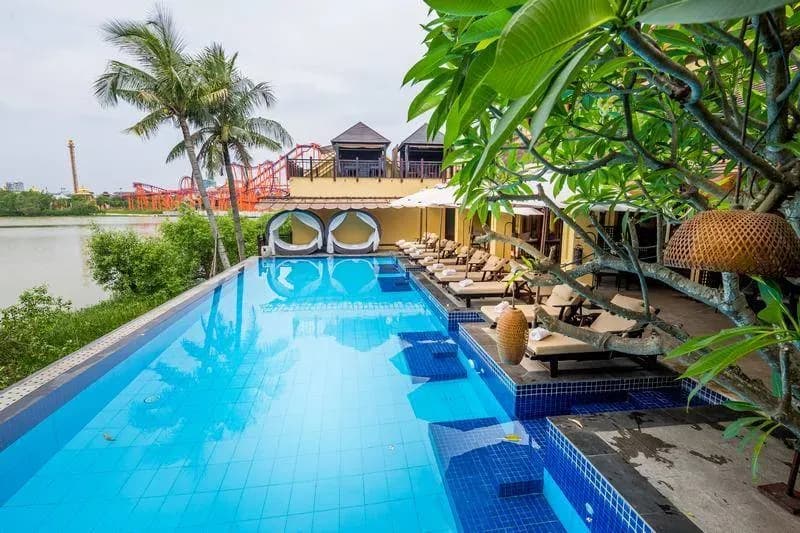 Infinity pool overlooking the river and nearby entertainment area.