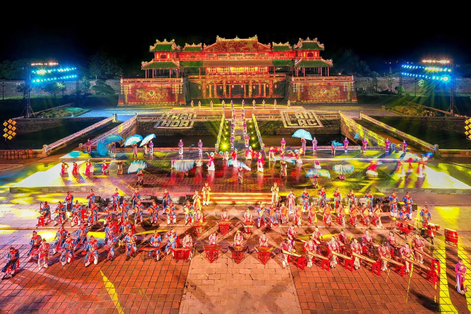 A Nha Nhac (Vietnamese court music) performance taking place on the ornate stage inside Thai Hoa Palace, with musicians in traditional costumes playing classical instruments